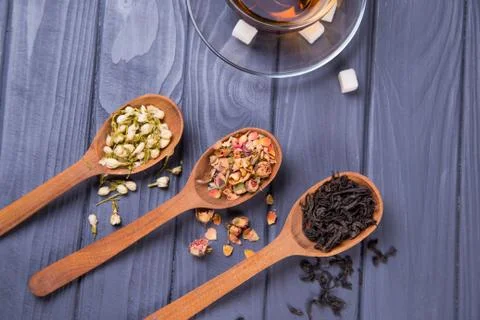 Dry tea in spoons Stock Photos
