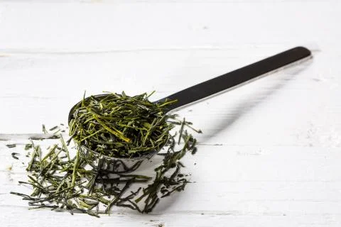 Dry tea on a teaspoon Stock Photos