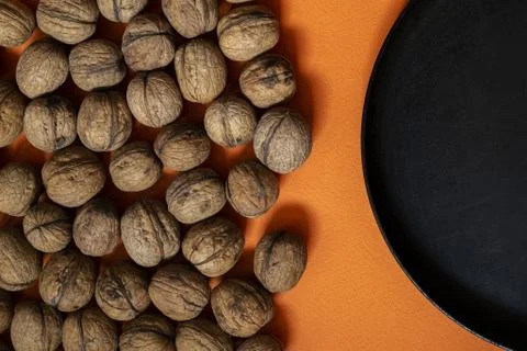 Dry walnuts on the orange background Stock Photos