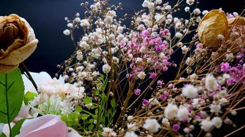 Dry white and pick Baby's Breath,Gypsophila and rose on spinning table Stock Footage 160517099