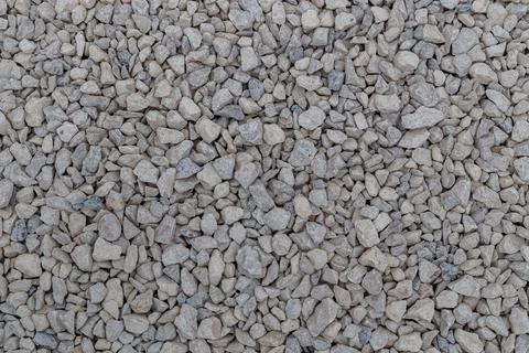 Dry white limestone ballast flat full frame background. Small gray dusty broken Photos