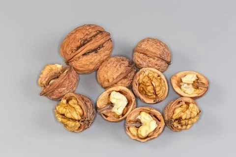 Dry whole and split walnuts on a gray background 写真素材