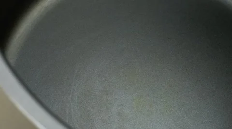 Dry yellow split peas pouring into metal cooking pot with crackling sounds of Stock Footage 62760375