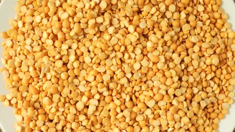 Dry yellow split peas rotating slowly Stock Footage 334861258