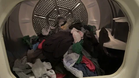 Dryer sheet being placed in dryer on clothes, 4k 動画素材 81377785