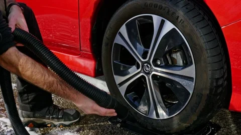 Drying alloy wheel and tyre Nissan Leaf with a car blow dryer - wide shot on a Stock Footage 331633090