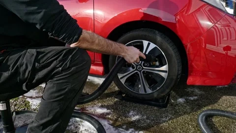 Drying alloy wheel and tyre Nissan Leaf with a car blow dryer - extreme wide Stock Footage 331633142