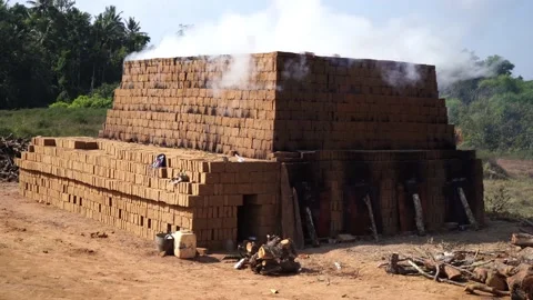 Drying and burning of bricks made of clay with fire wood Stock Footage 198005902