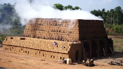 Drying and burning of bricks made of clay with fire wood Stock Footage 198005931