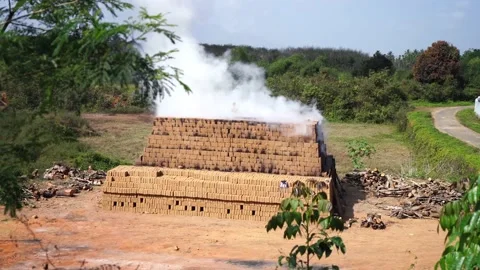 Drying and burning of bricks made of clay with fire wood Stock Footage 198005955