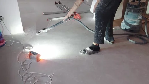 Drying and cleaning of a floor in a construction area during the afternoon Stock Footage 331245267