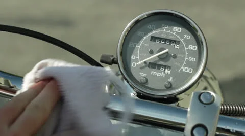 Drying off and polishing motorcycle speedometer and handlebars cu Stock Footage 24635778