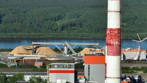 Drying and storage of wood chips in piles. General view of the paper mill Stock Footage 321675635