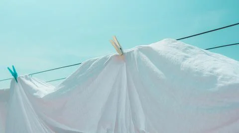 Drying bed sheets outdoor in hot summer air Stock Photos