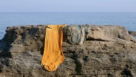 Drying clothes on a big rock stone at the shore near the sea Video stock 111701823