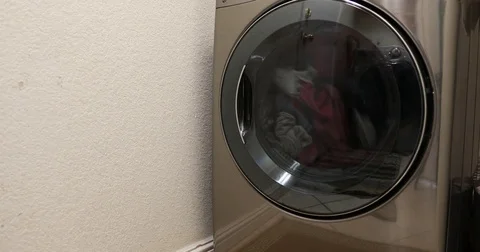 Drying clothes in grey machine Stock Footage 84852351