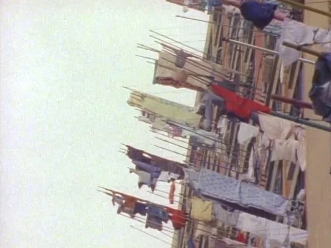Drying clothes hanging outside the window of an building Stock Footage 79878544