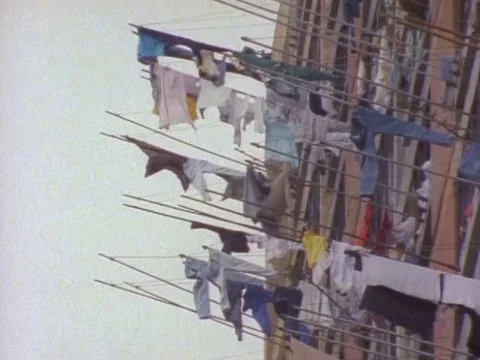 Drying clothes hanging outside the window of an building Stock Footage 79878714