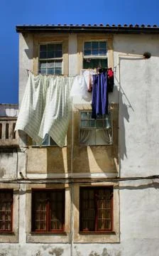 Drying clothes on house window Stock Photos
