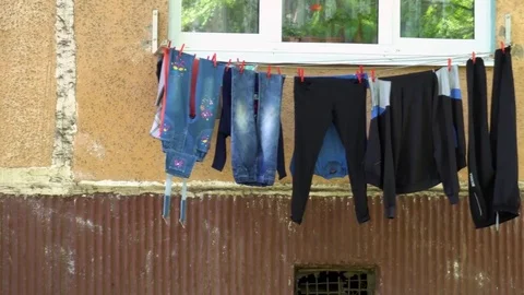 Drying clothes outside the window of a residential building Stock Footage 75446739