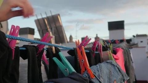 Drying clothes in the wind with clothespins on a rooftop terrace Stock Footage 124647049