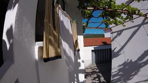 Drying clothes on window in sunny and windy day Stock Footage 81199339