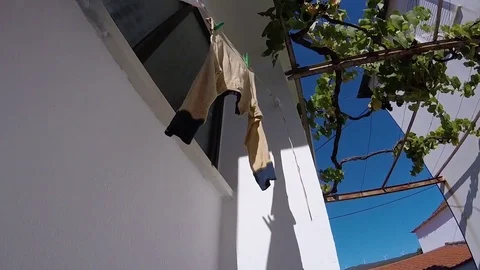 Drying clothes on window in sunny and windy day Stock Footage 81199346
