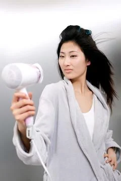 Drying Facial expression Get ready. Young woman Oriental figures Women Hairdryer Stock Photos