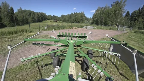 Drying hay by turning with a rotor tractor rake Stock Footage 111928187
