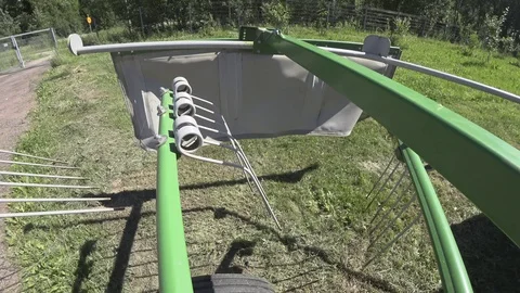 Drying hay by turning with a rotor tractor rake Stock Footage 111928191