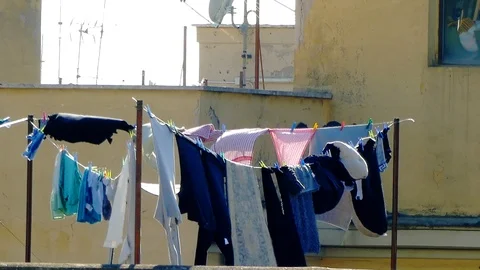 Drying laundry on the clothesline on building terrace. Clean washed laundry 스톡 동영상 126705111