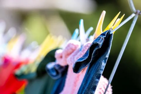 Drying laundry on the clothesline close up outdoors. Stock Photos