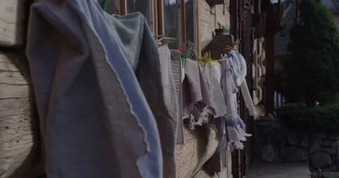 Drying laundry outside rustic wooden house  Stock Footage 147633029