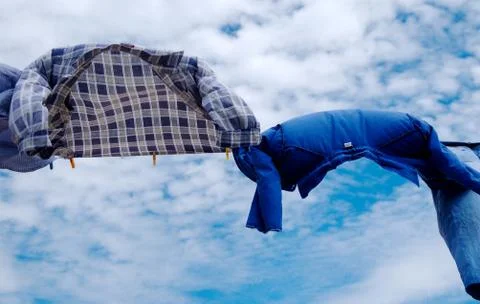 Drying line shirts on wind with copy space on sky  background Stock Photos