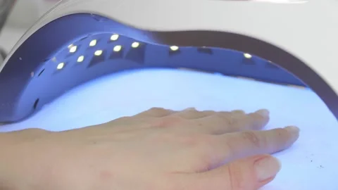 Drying manicure in a special lamp Stock Footage 195736824