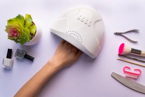 Drying of nails in an ultraviolet lamp Stock Photos