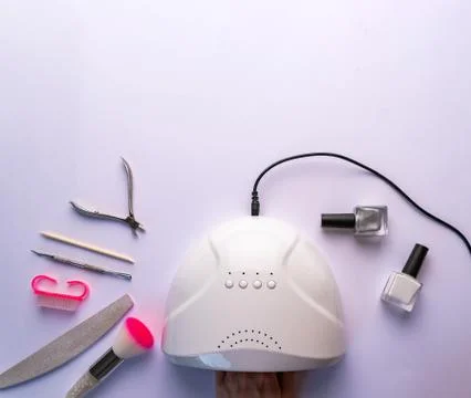 Drying of nails in an ultraviolet lamp Stock Photos