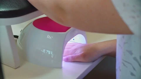 Drying nails in ultraviolet. Services of a master of manicure. Stock Footage 152986964