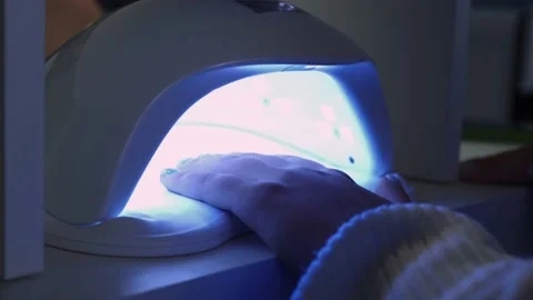 Drying nails under ultraviolet light, cuticle moisturizing Stock Footage 206391548
