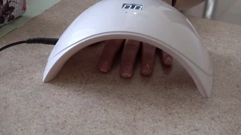 Drying nails in the UV Lamp Nail Dryer Machine Stock Footage 74110014