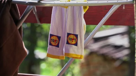 Drying pair of socks with Lidl logo. Stock Footage 344740864