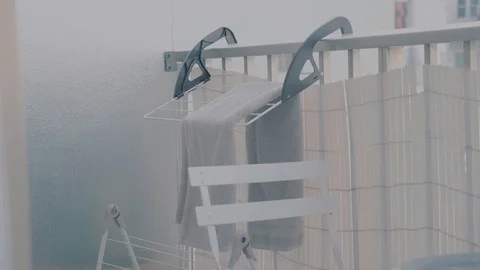 Drying rack with a towel on a balcony Stock Footage 98368518