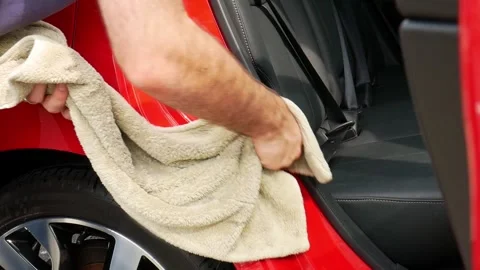 Drying red car door shuts with a yellow microfiber drying towel Stock Footage 321036978