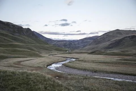 Drying river bed in a mountain valley Stock Photos