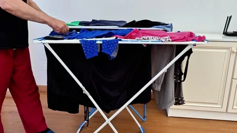 Drying Washed Clothes on Collapsible Laundry Rack Stock Footage 338317588