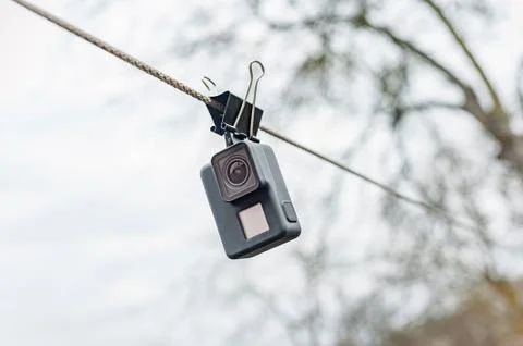 Drying waterproof action camera on the clip, against the sky. 스톡 사진