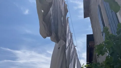 Drying White bed sheets outdoor, vine plants italian Landscape Stock Footage 329671854