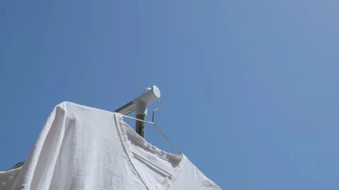 Drying white shirt by sunlight. Stock Footage 155913322