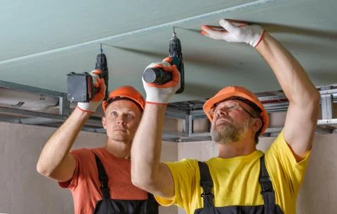 Drywall installation on the ceiling. Stock Photos