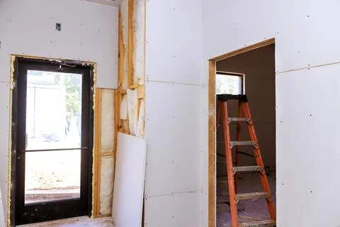 Drywall installation process in residential building during work daytime near Stock Photos